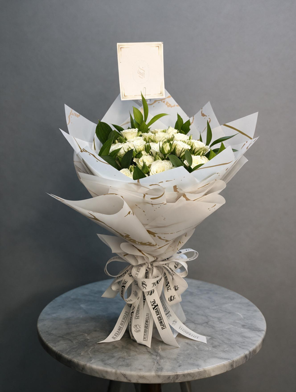 Pulse of Hearts" bouquet featuring premium white Baby Roses