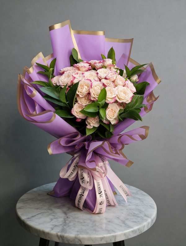 "Mauve Elegance" bouquet featuring creamy Baby Roses tinged with fuchsia